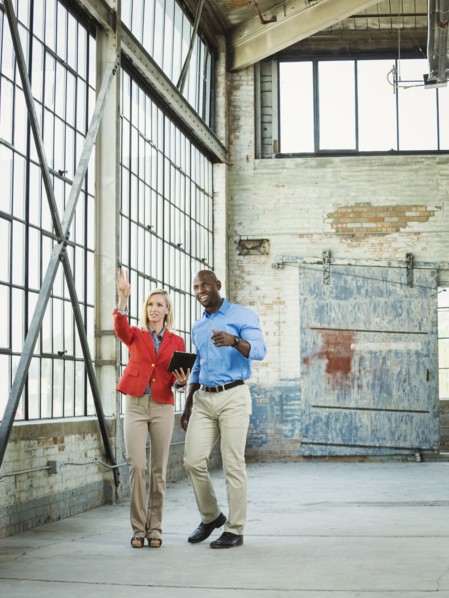 Business people using digital tablet in warehouse