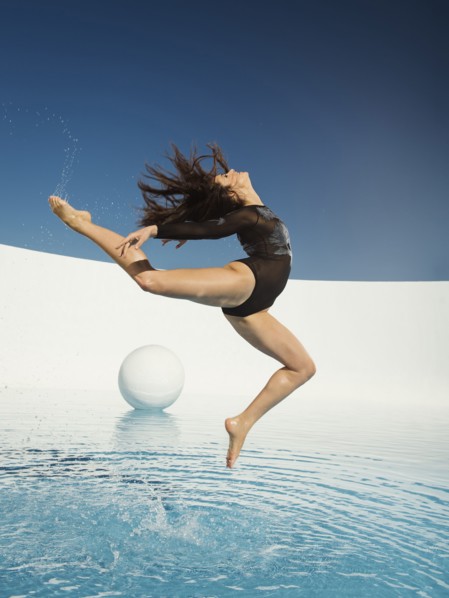 Caucasian woman dancing on water surface