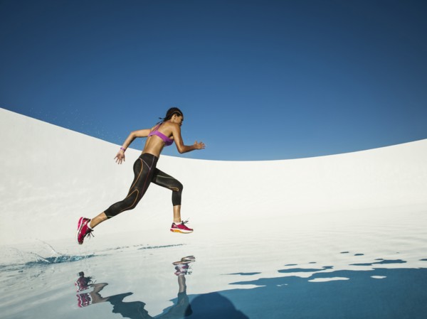 Mixed race woman running on water surface