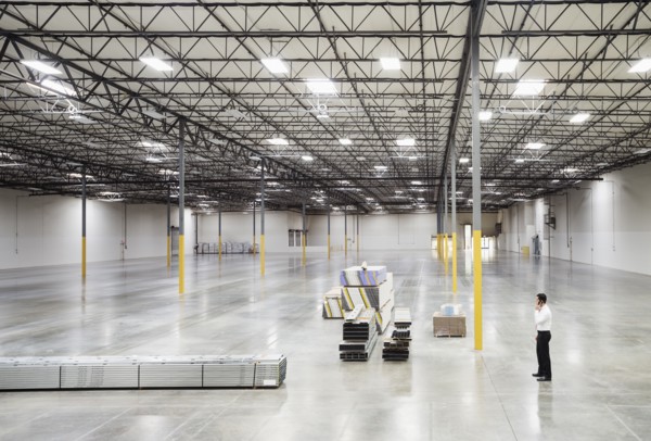 Caucasian businessman standing in empty warehouse