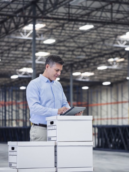 Caucasian businessman using digital tablet in empty warehouse
