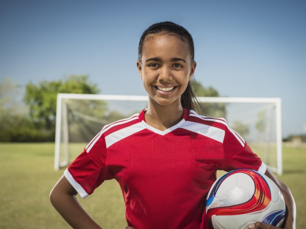 Mixed race soccer player standing on field