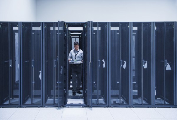 Hispanic technician working in server room