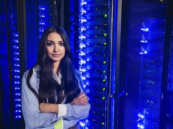 Mixed race technician standing in server room