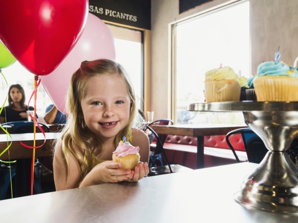 Caucasian girl celebrating birthday in cafe