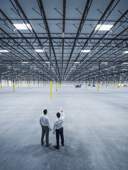 Businessmen talking in empty warehouse