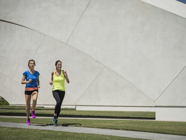 Caucasian women running near architecture