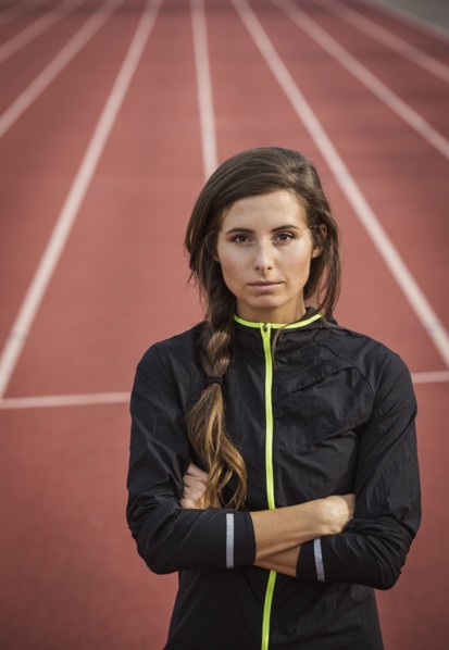 Caucasian woman posing on running track