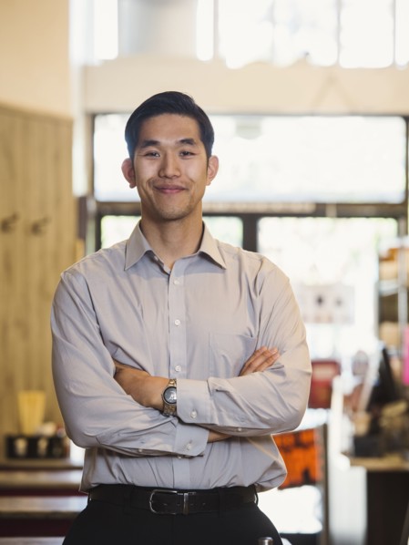 Smiling Chinese man posing in restaurant