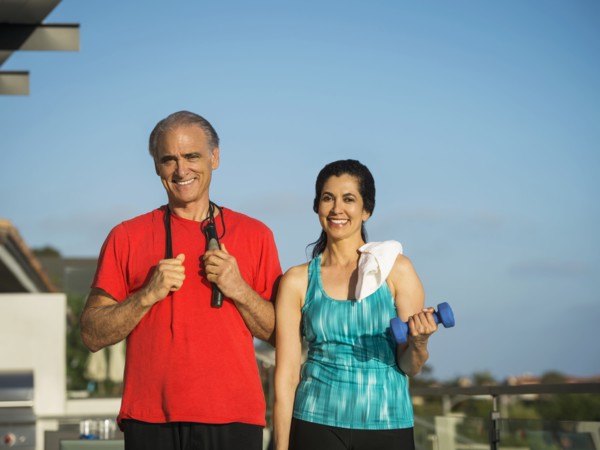 Portrait of older couple resting outdoors after workout