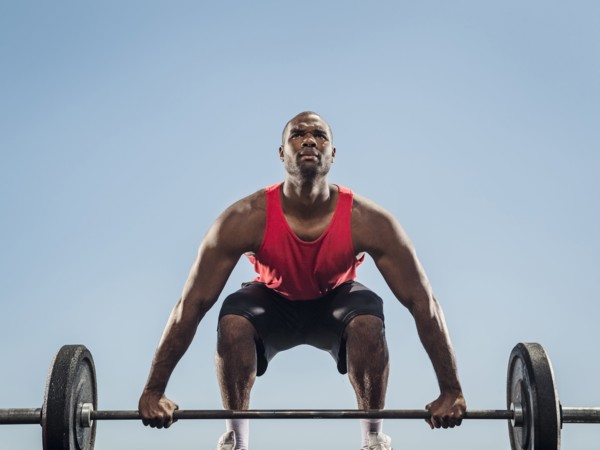 Black man preparing for lifting barbell