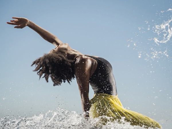 Black woman dancing in water
