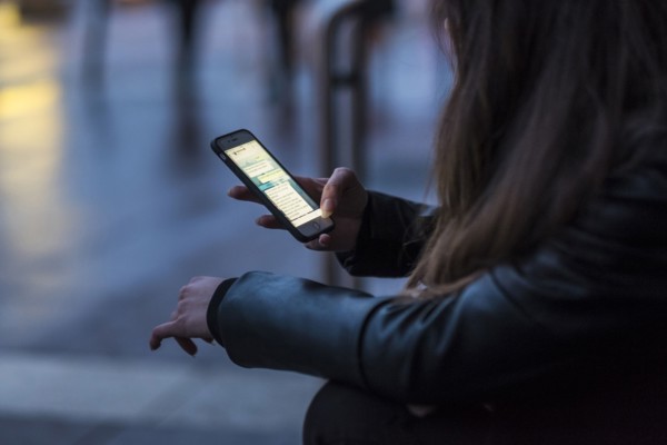 Caucasian woman texting on cell phone outdoors