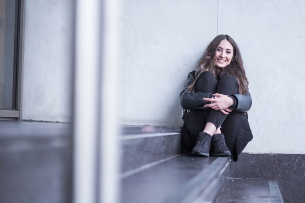 Smiling Caucasian woman sitting on staircase