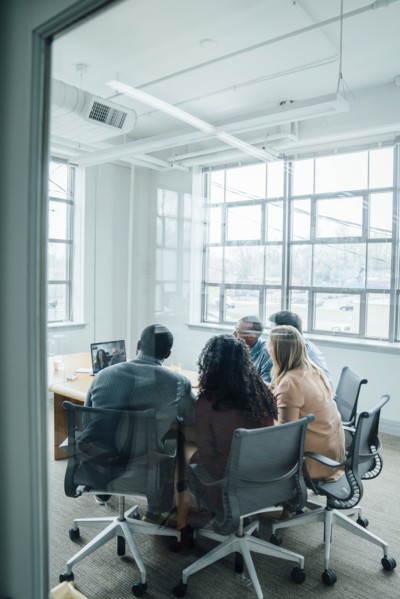 Business people on video conference behind window