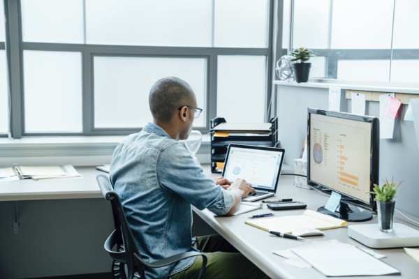 Black businessman using laptop in office