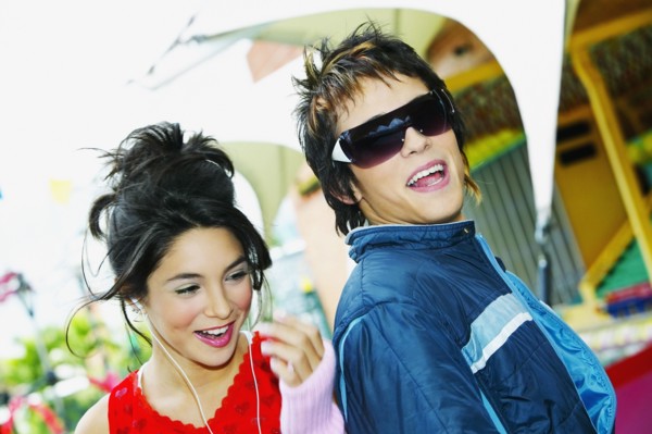 Young Hispanic couple smiling at carnival