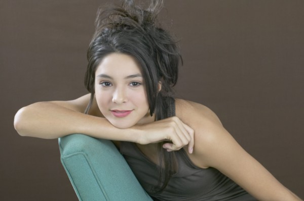 Hispanic girl resting chin on arm