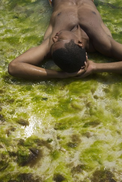Hispanic man laying in water