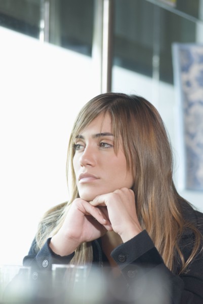 Hispanic woman looking out window