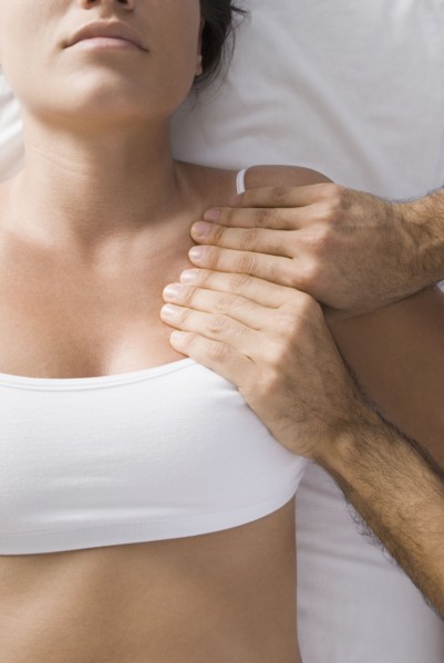 Chiropractor adjusting woman's shoulder