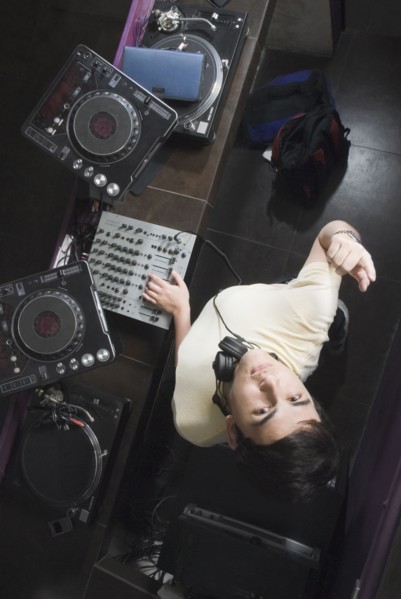 Hispanic DJ performing in nightclub