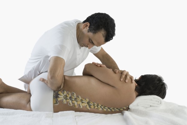 Chiropractor adjusting man's back