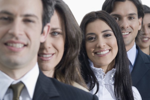 Hispanic co-workers standing in row