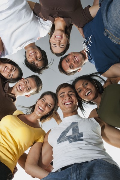 Smiling friends in huddle together