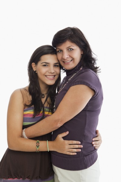Hispanic mother hugging daughter
