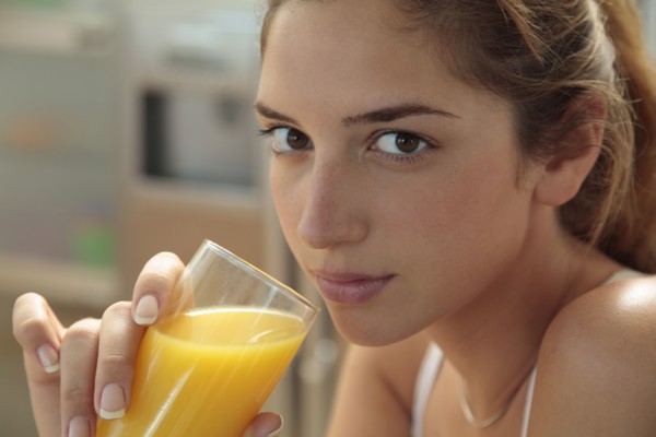 Caucasian woman drinking orange juice