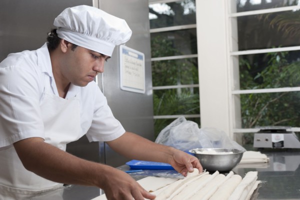 Hispanic baker working in commercial kitchen