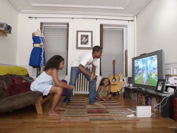 Brother and sister playing video game in living room