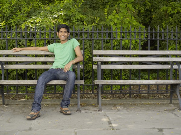 Indian man relaxing on park bench