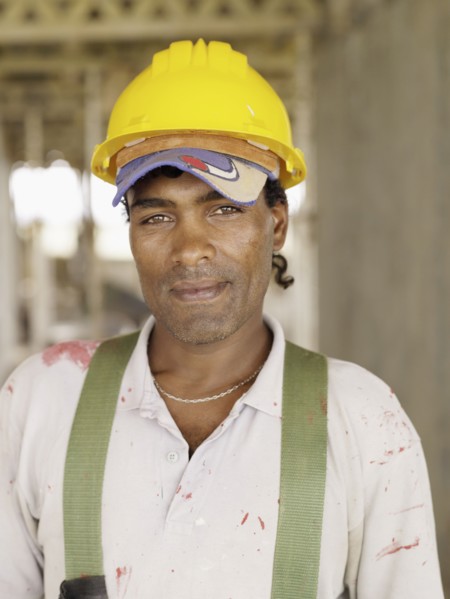 Hispanic worker smiling on construction site