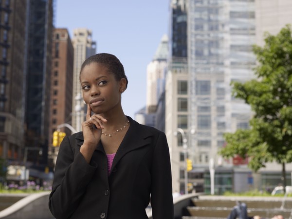 African businesswoman on street looking pensive