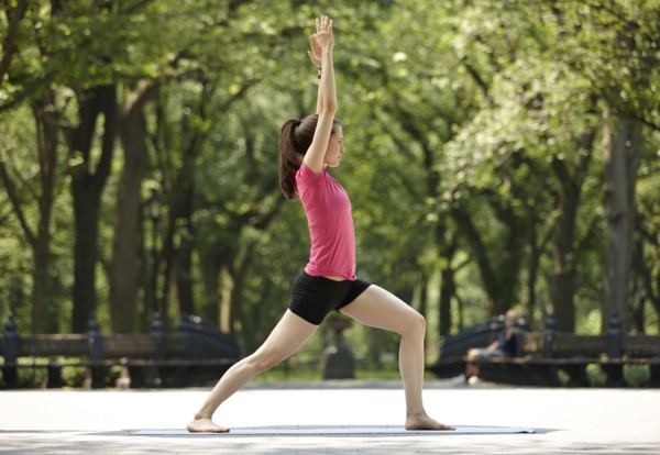 Caucasian woman practicing yoga in park
