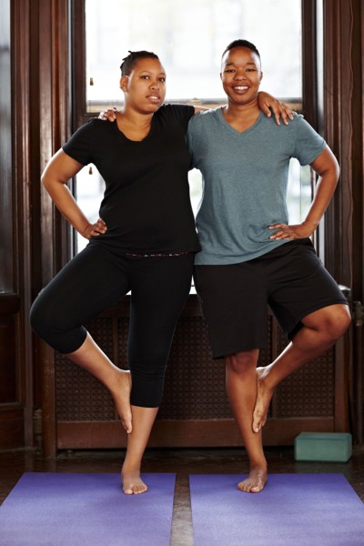 Women balancing together in yoga class
