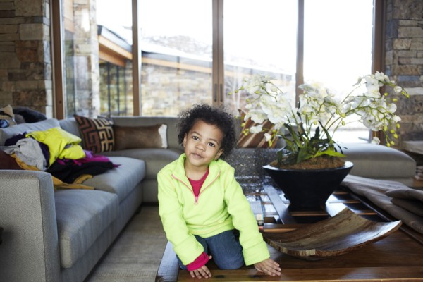 Mixed race girl sitting on coffee table