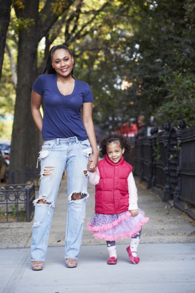 Mother and daughter standing on city street