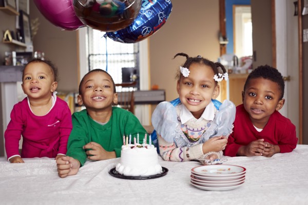 Smiling children with cake at party