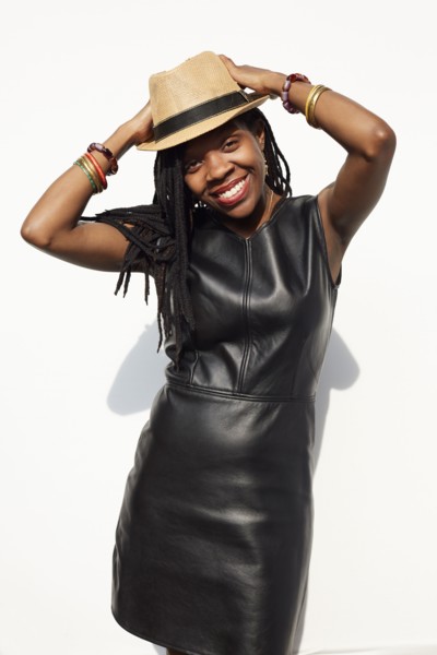 African American woman wearing leather dress and straw hat