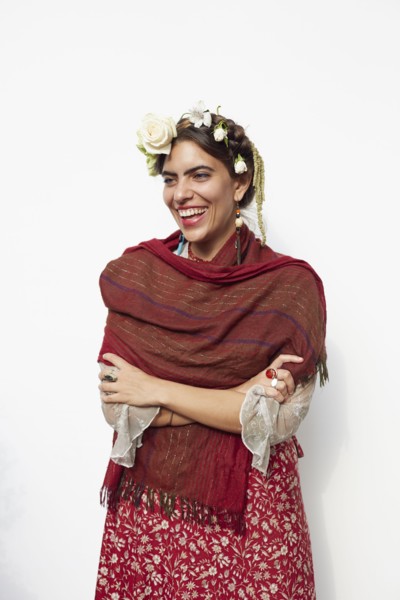 Stylish woman wearing shawl and flowers in hair