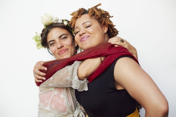 Stylish smiling women hugging