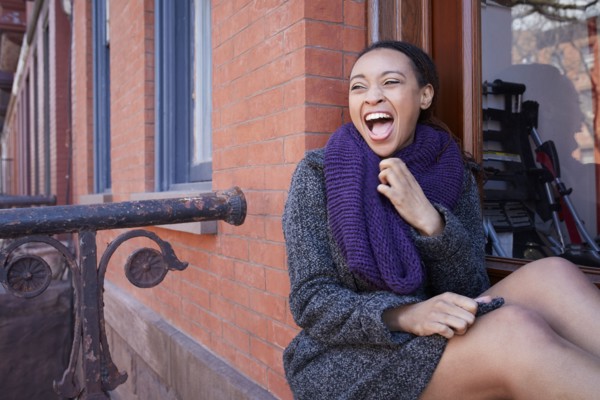 African American woman laughing in window