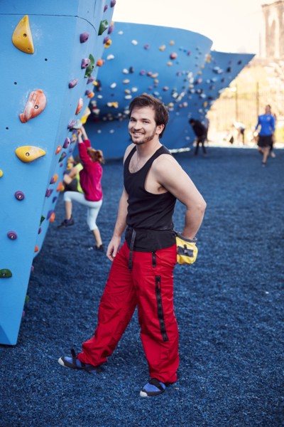 Caucasian man posing at outdoor climbing wall