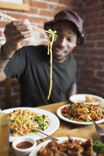African American man eating at restaurant