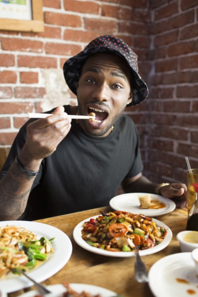African American man eating at restaurant