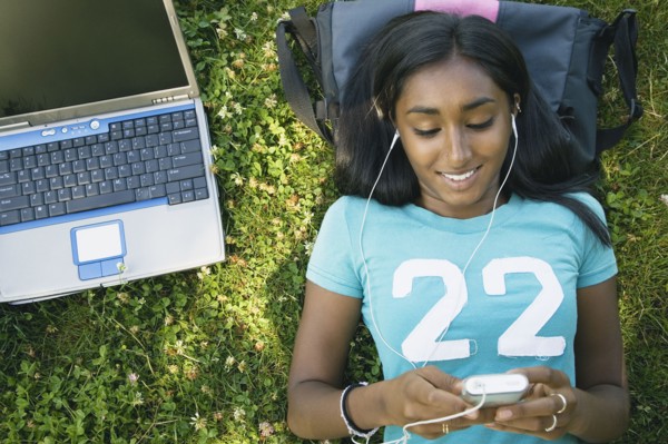 Indian female college student listening to mp3 player