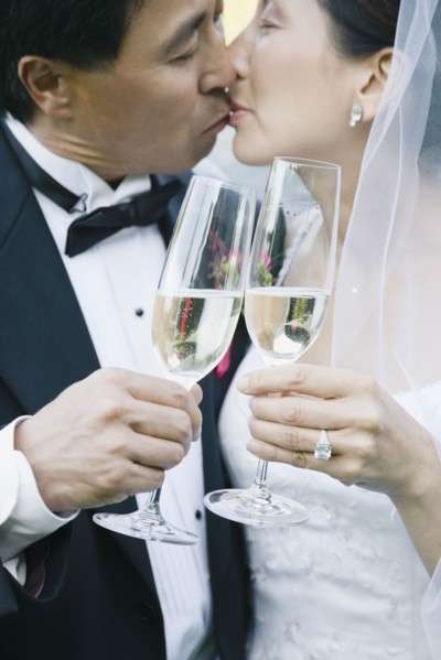 Asian newlyweds kissing